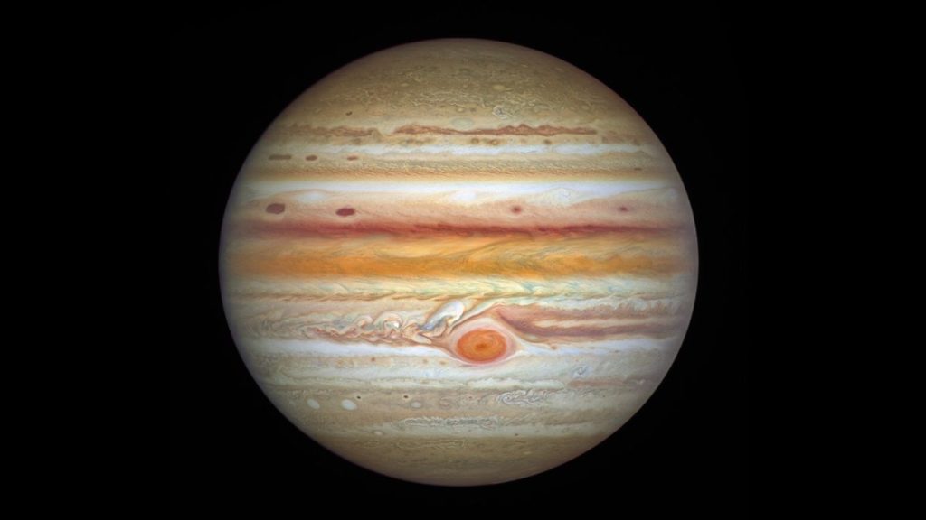 An image of the giant gas planet Jupiter, which looks like a ball with white, brown, and red spots.