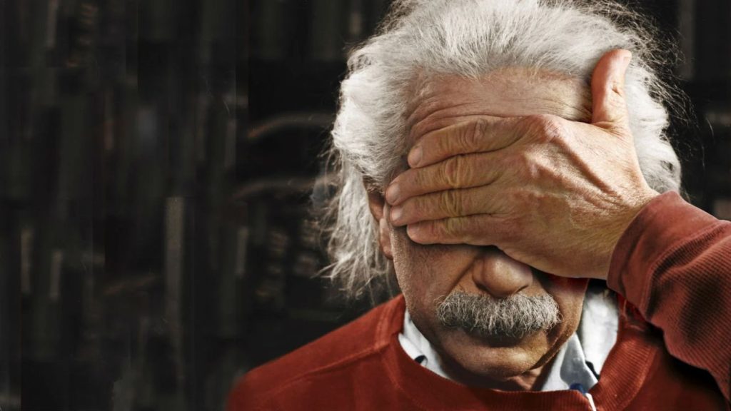 Albert Einstein met hand voor zijn ogen
